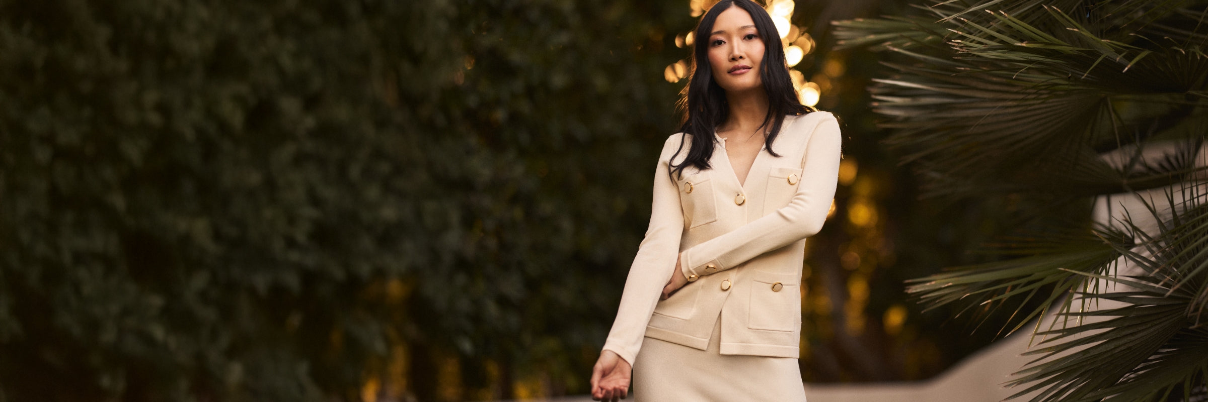 Woman wearing St John jacket and matching skirt in ecru from the Spring 25 collection